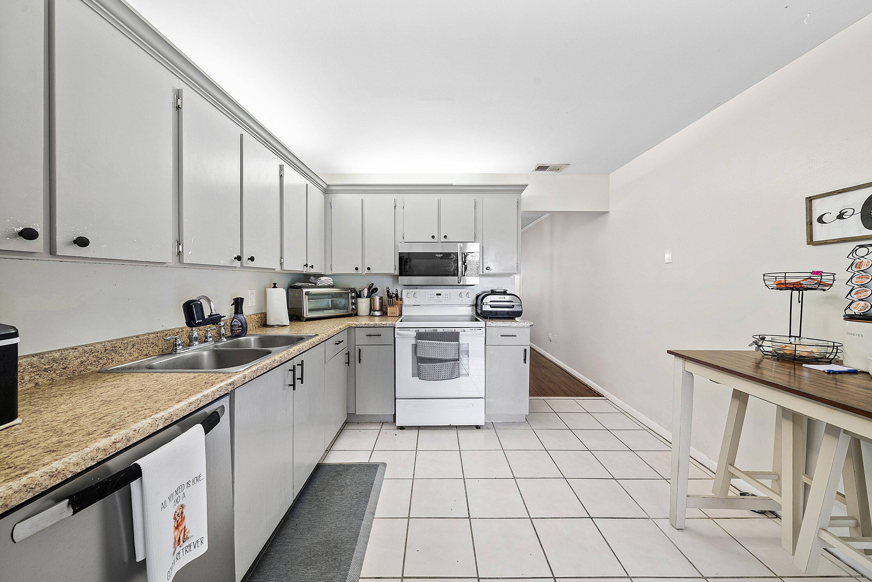 4500 Southeast Salvatori Road Stuart, FL 34997 - Photo 18 of 25 a kitchen with stainless steel appliances granite countertop a sink and cabinets