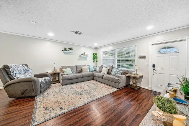 a living room with furniture and wooden floor