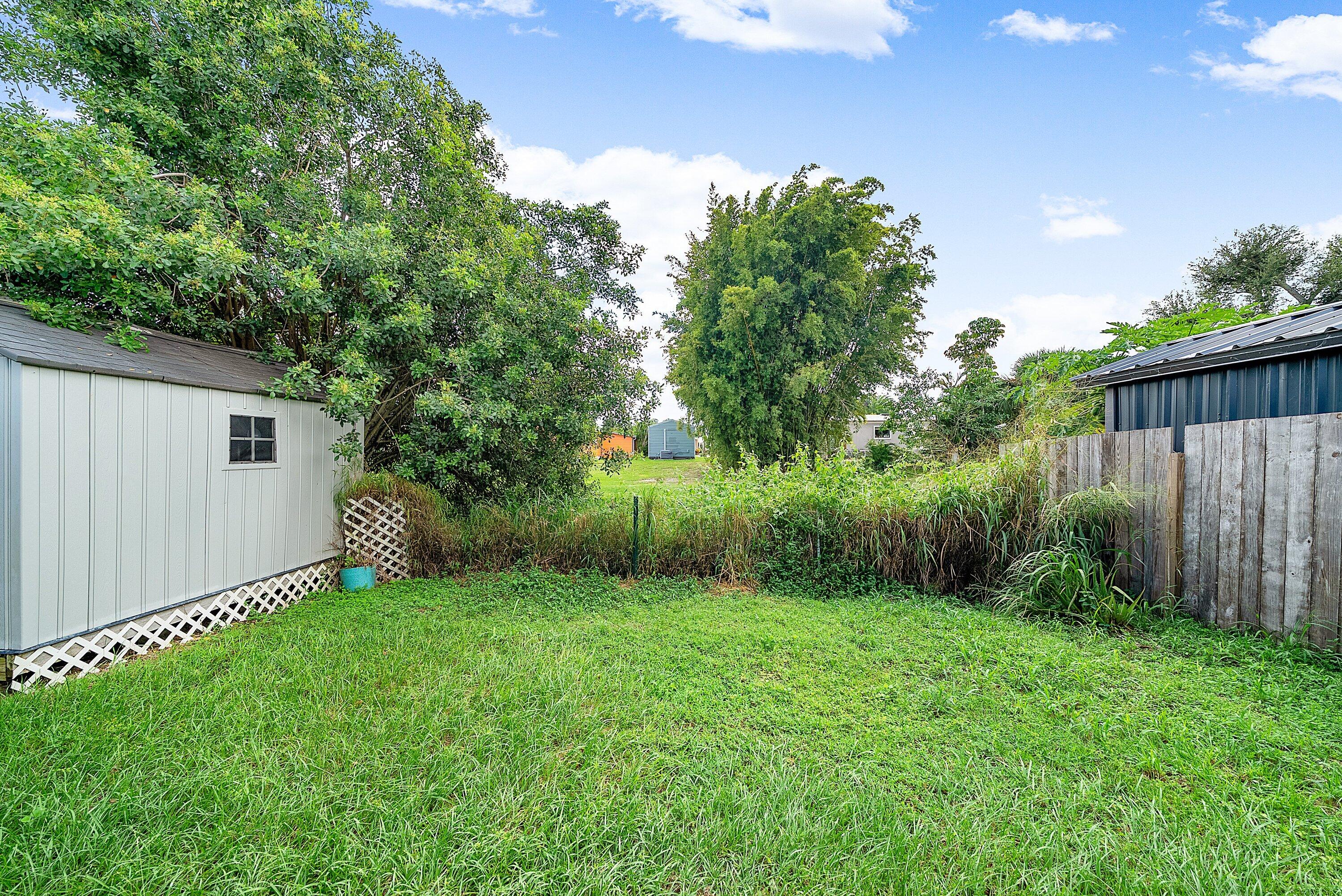 4500 Southeast Salvatori Road Stuart, FL 34997 - Photo 21 of 25 a view of a backyard with a garden