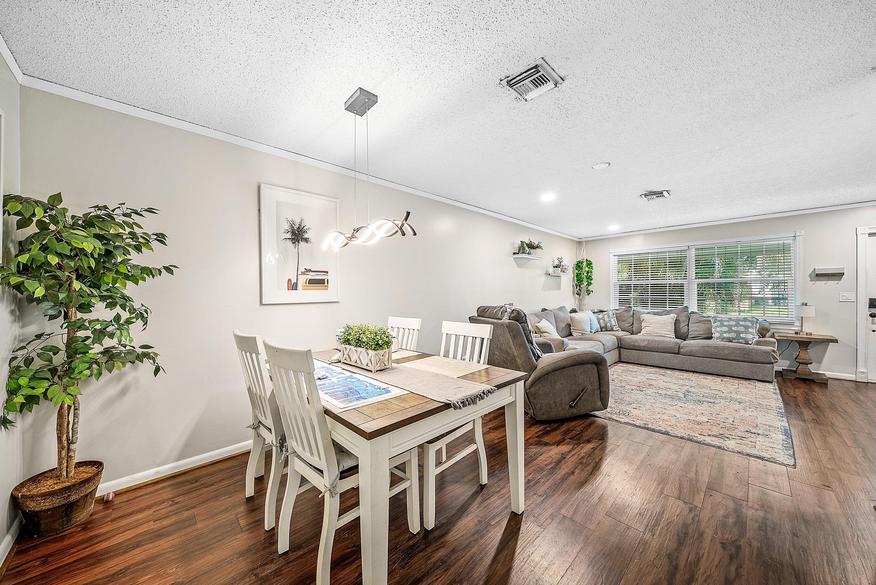 4500 Southeast Salvatori Road Stuart, FL 34997 - Photo 6 of 25 a view of a dining room with furniture and wooden floor