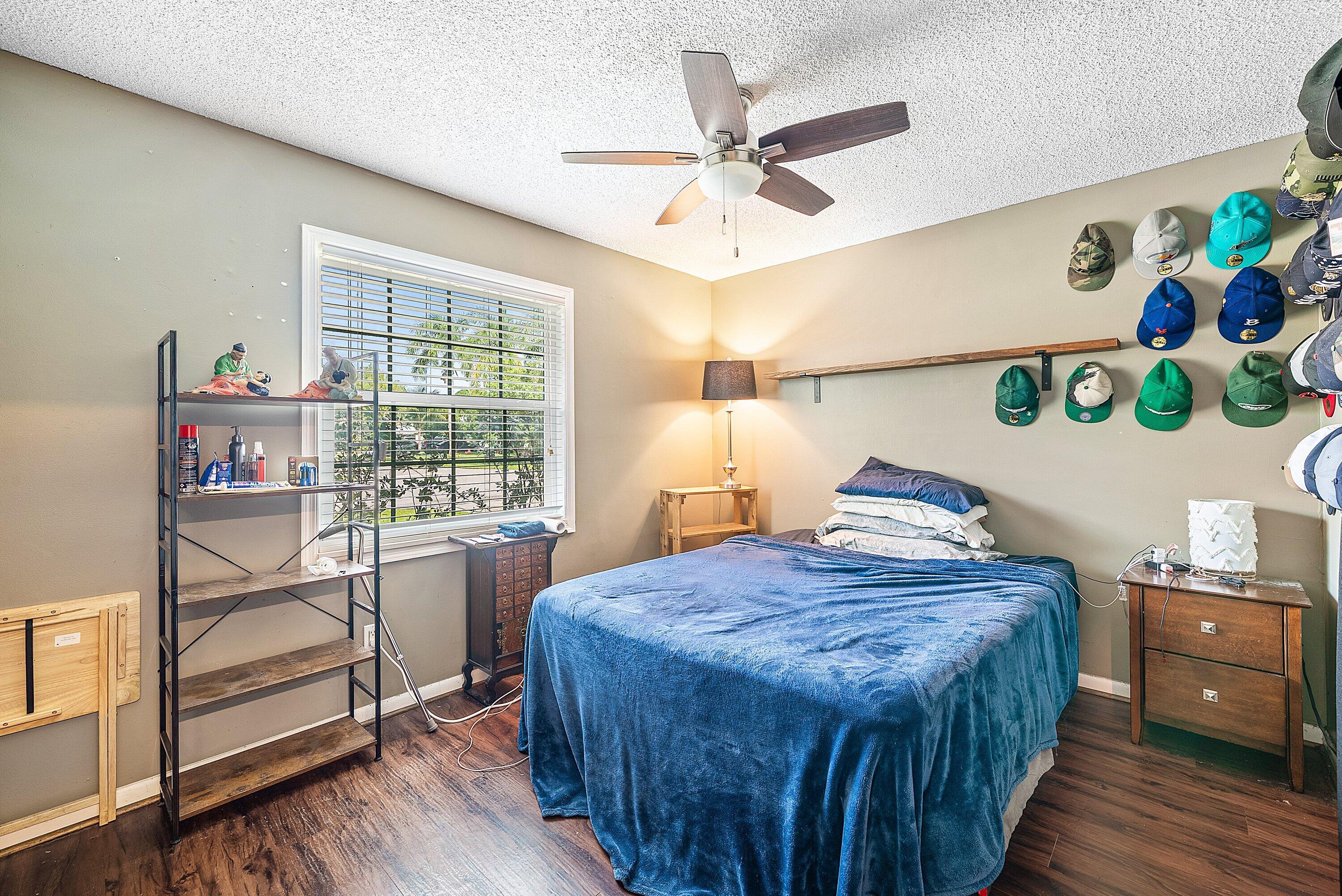 4500 Southeast Salvatori Road Stuart, FL 34997 - Photo 7 of 25 a bedroom with a bed and a chandelier