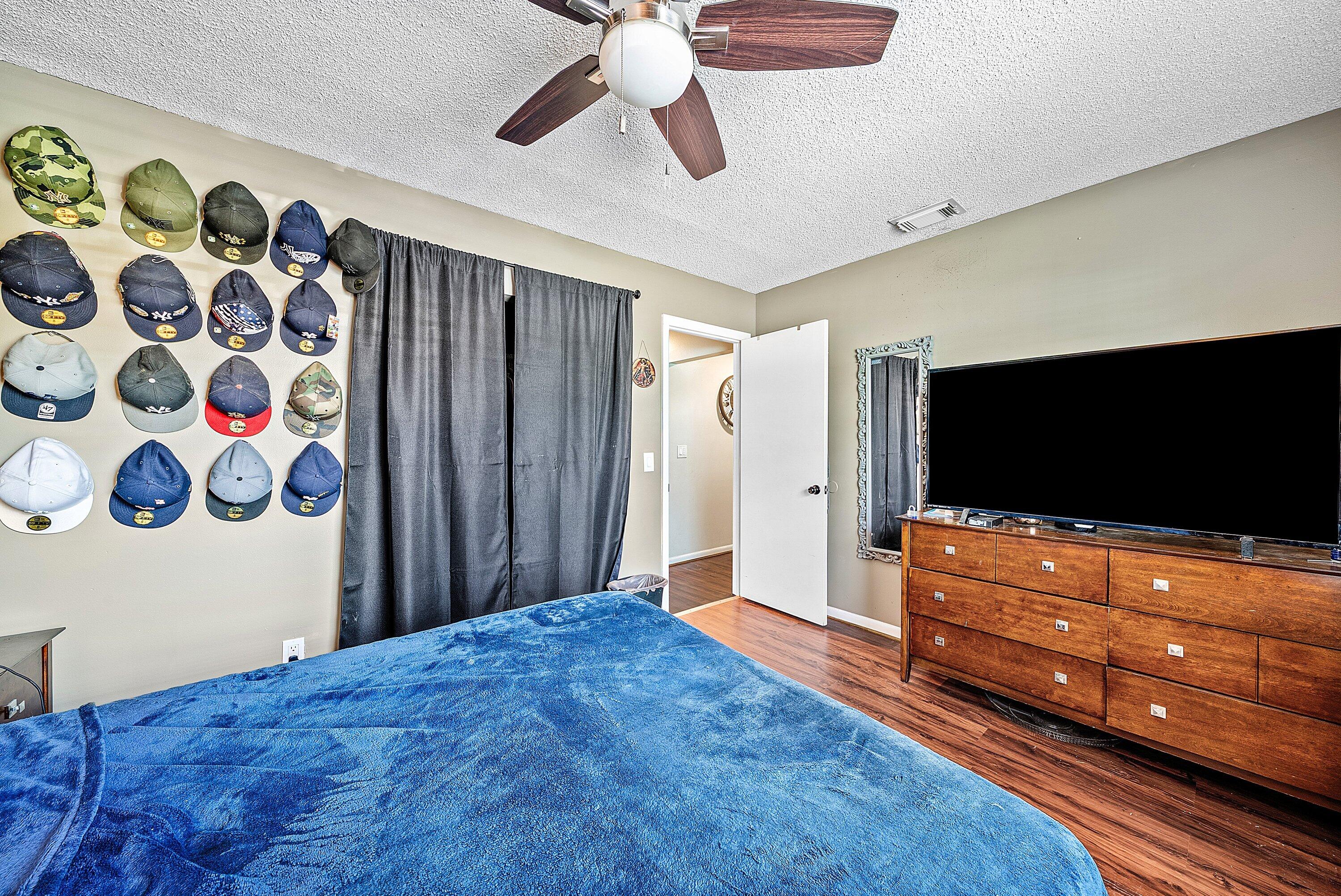 4500 Southeast Salvatori Road Stuart, FL 34997 - Photo 8 of 25 a bedroom with a bed and flat screen tv
