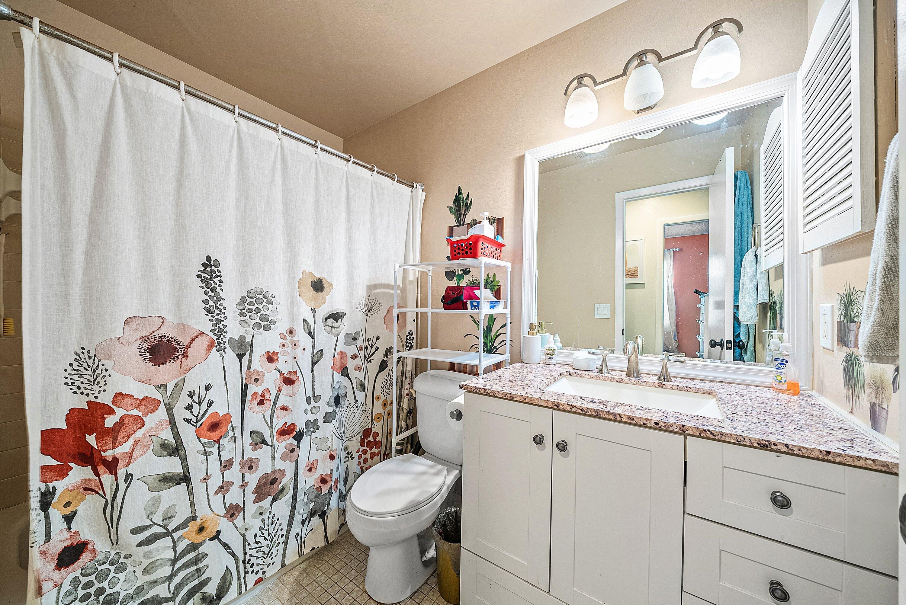 4500 Southeast Salvatori Road Stuart, FL 34997 - Photo 9 of 25 a bathroom with a toilet sink and mirror