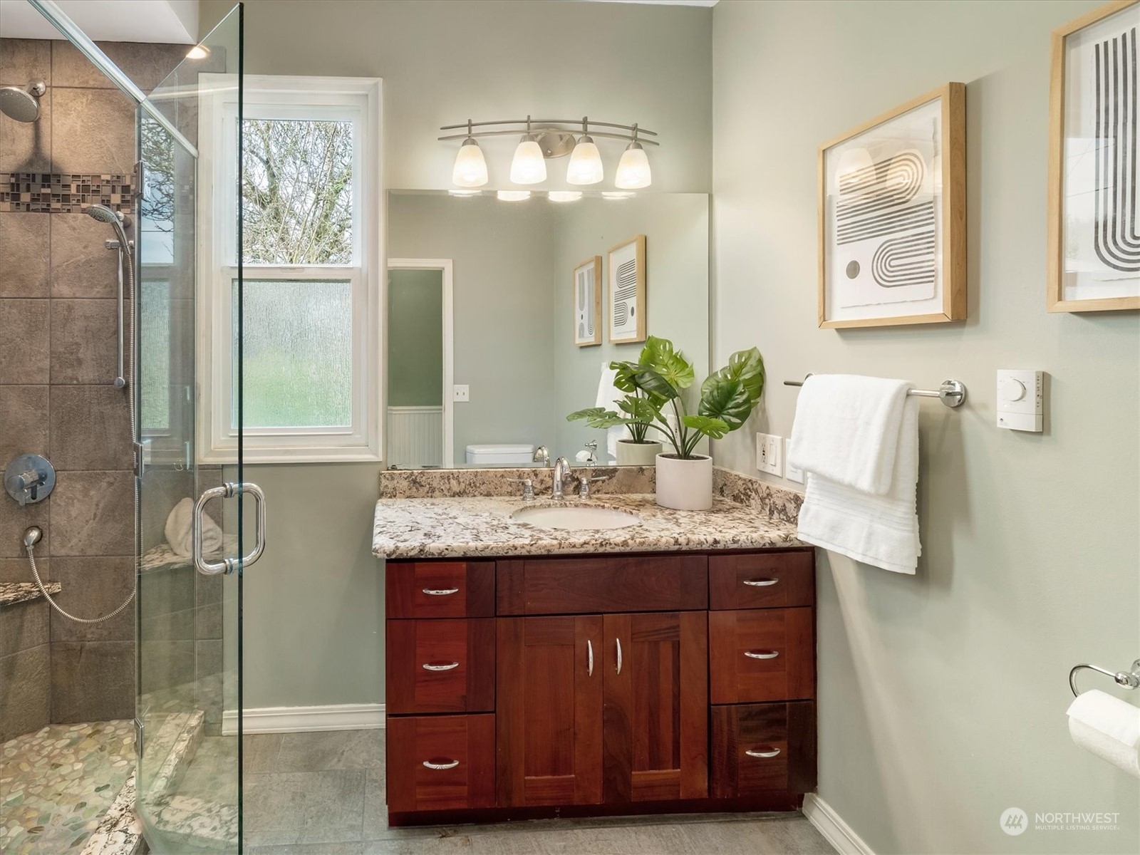 610 Maple Street Edmonds, WA 98020 - Photo 18 of 36 a bathroom with a granite countertop sink a mirror and a shower