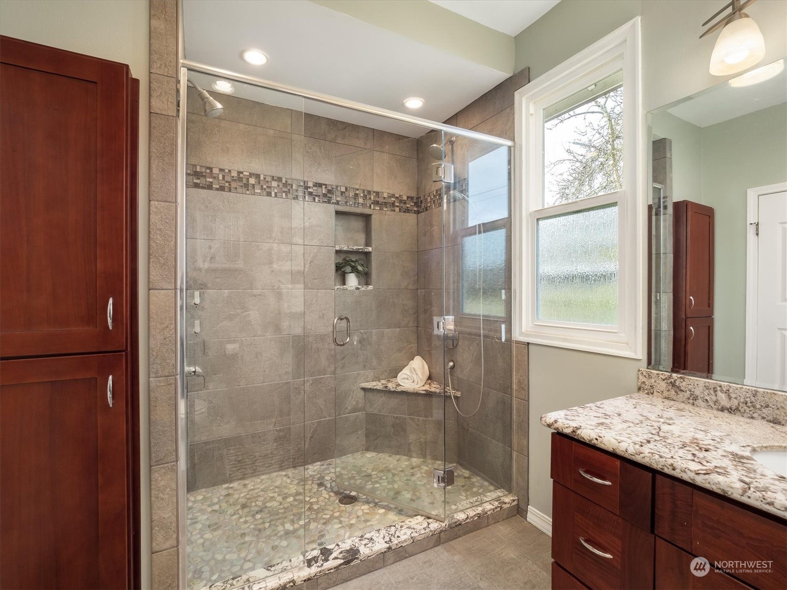 610 Maple Street Edmonds, WA 98020 - Photo 19 of 36 a bathroom with a granite countertop sink a shower and a mirror
