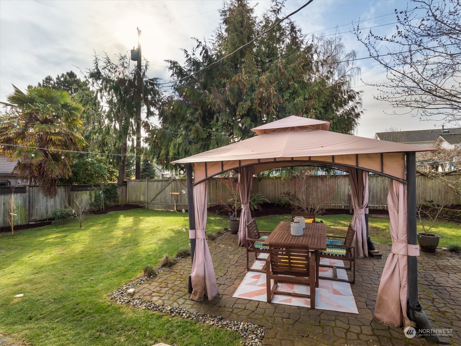 610 Maple Street Edmonds, WA 98020 - Photo 25 of 36 a view of a patio with a table chairs and a yard