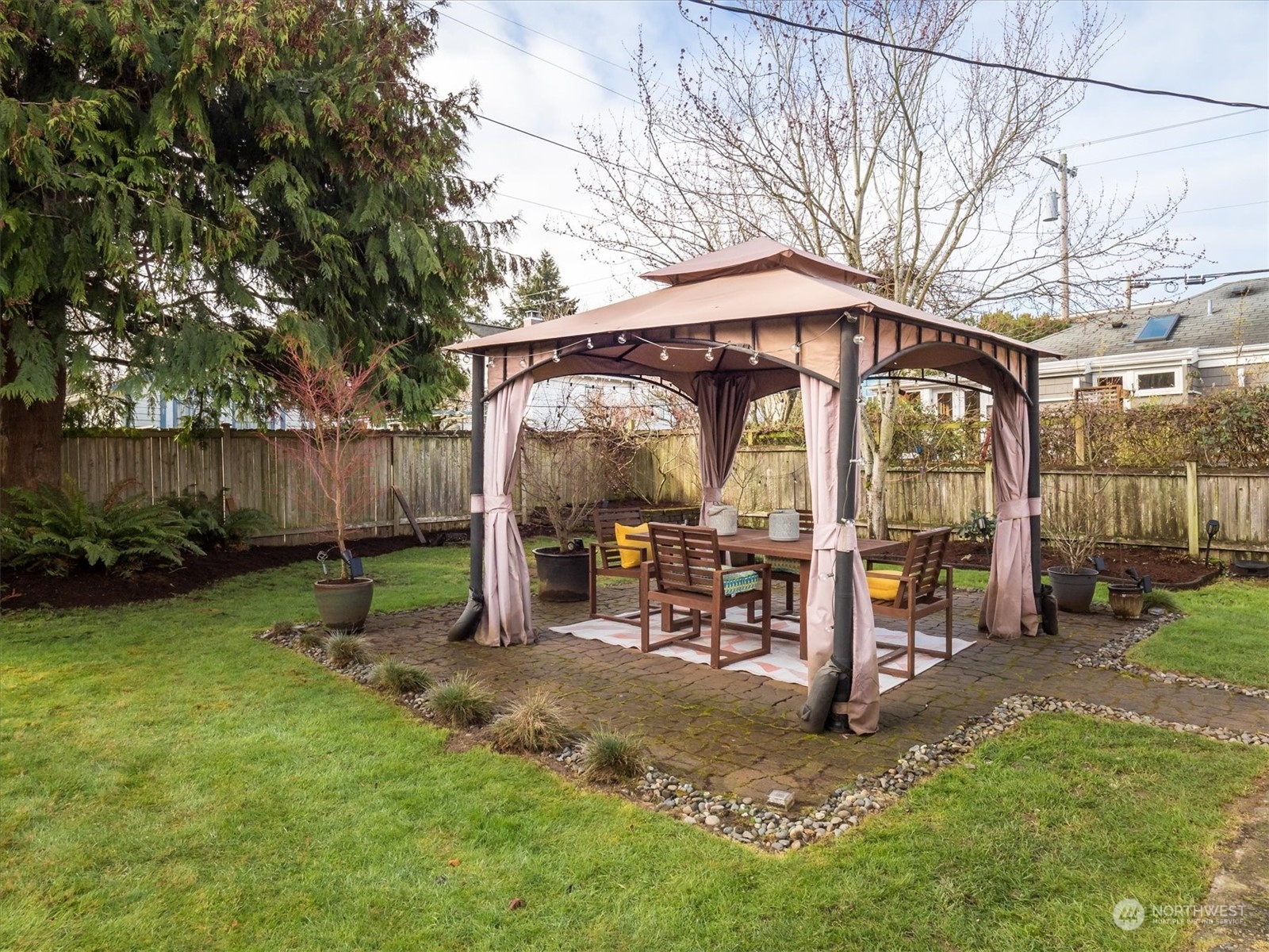610 Maple Street Edmonds, WA 98020 - Photo 26 of 36 a view of a chair and table in backyard of the house