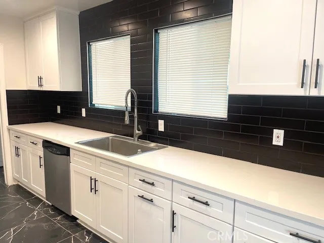 a kitchen with a sink and a window