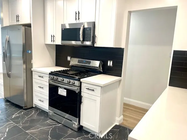 a kitchen with a stove and a refrigerator