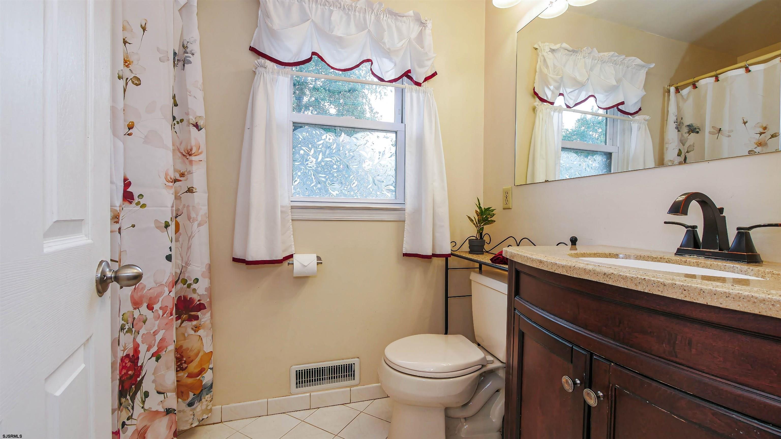 2 Rose Lane Somers Point, NJ 08244 - Photo 14 of 43 a bathroom with a sink a toilet and a mirror