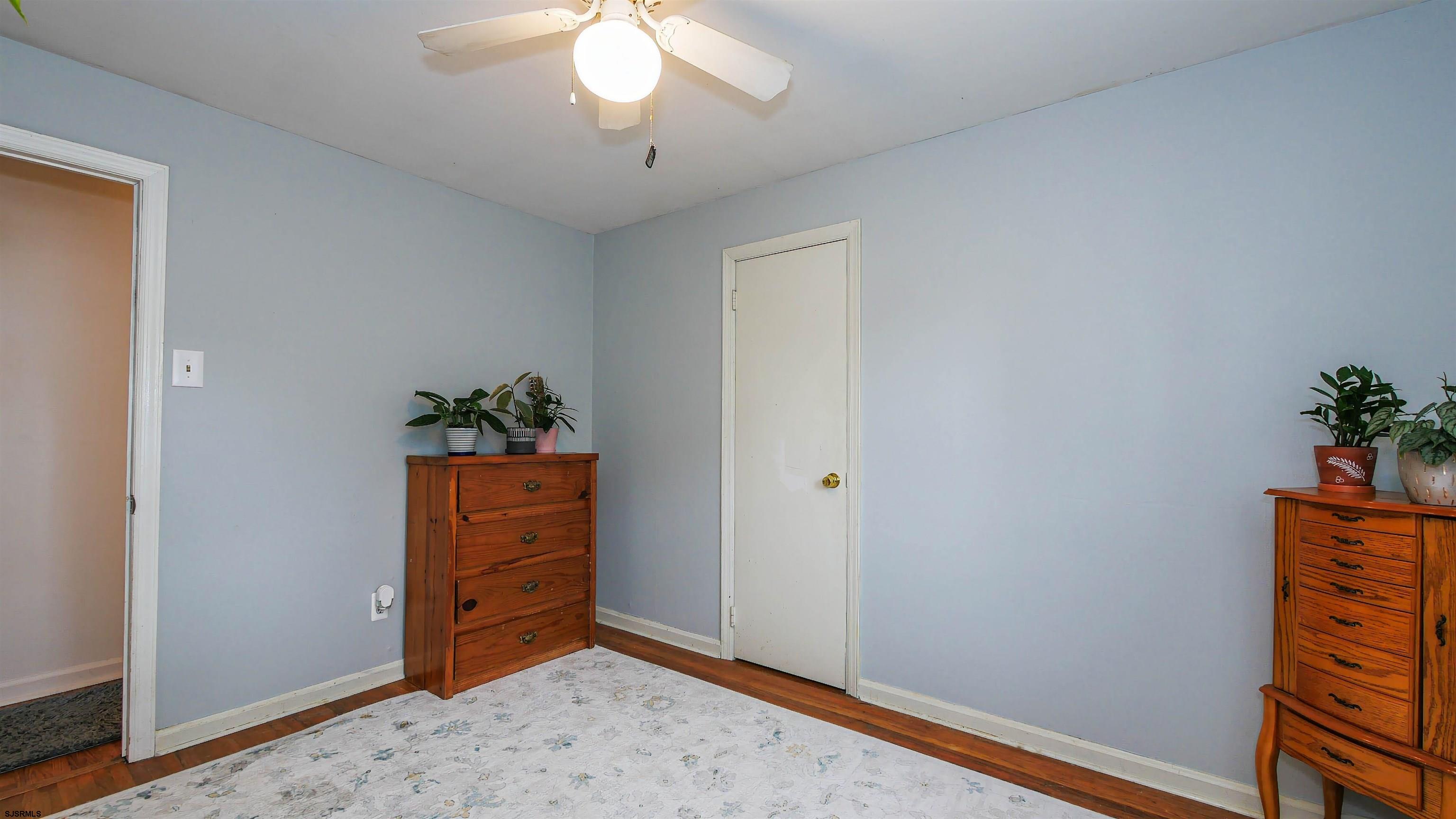 2 Rose Lane Somers Point, NJ 08244 - Photo 17 of 43 an empty room with potted plant and wooden floor