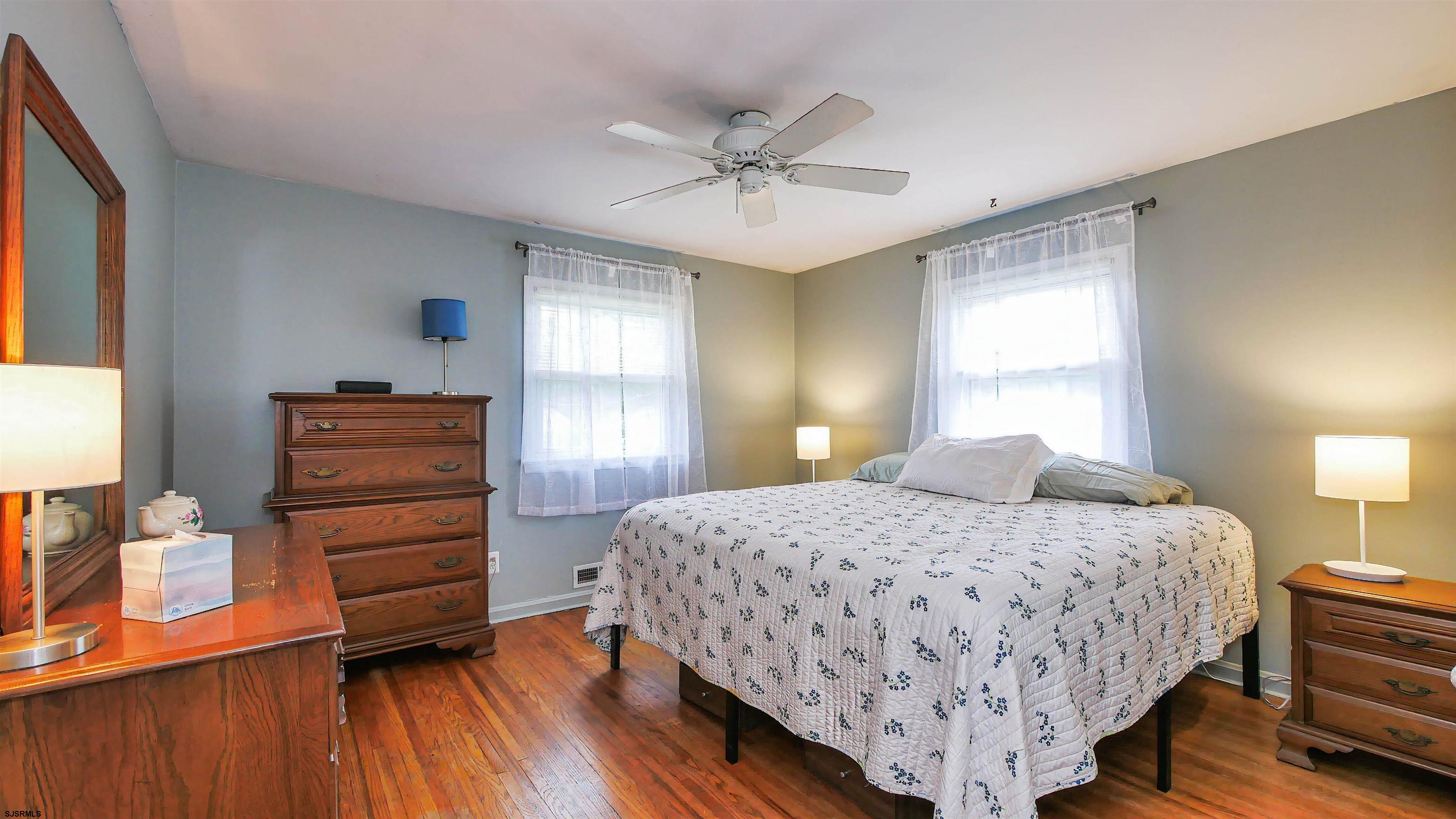 2 Rose Lane Somers Point, NJ 08244 - Photo 18 of 43 a bedroom with a bed and wooden floor