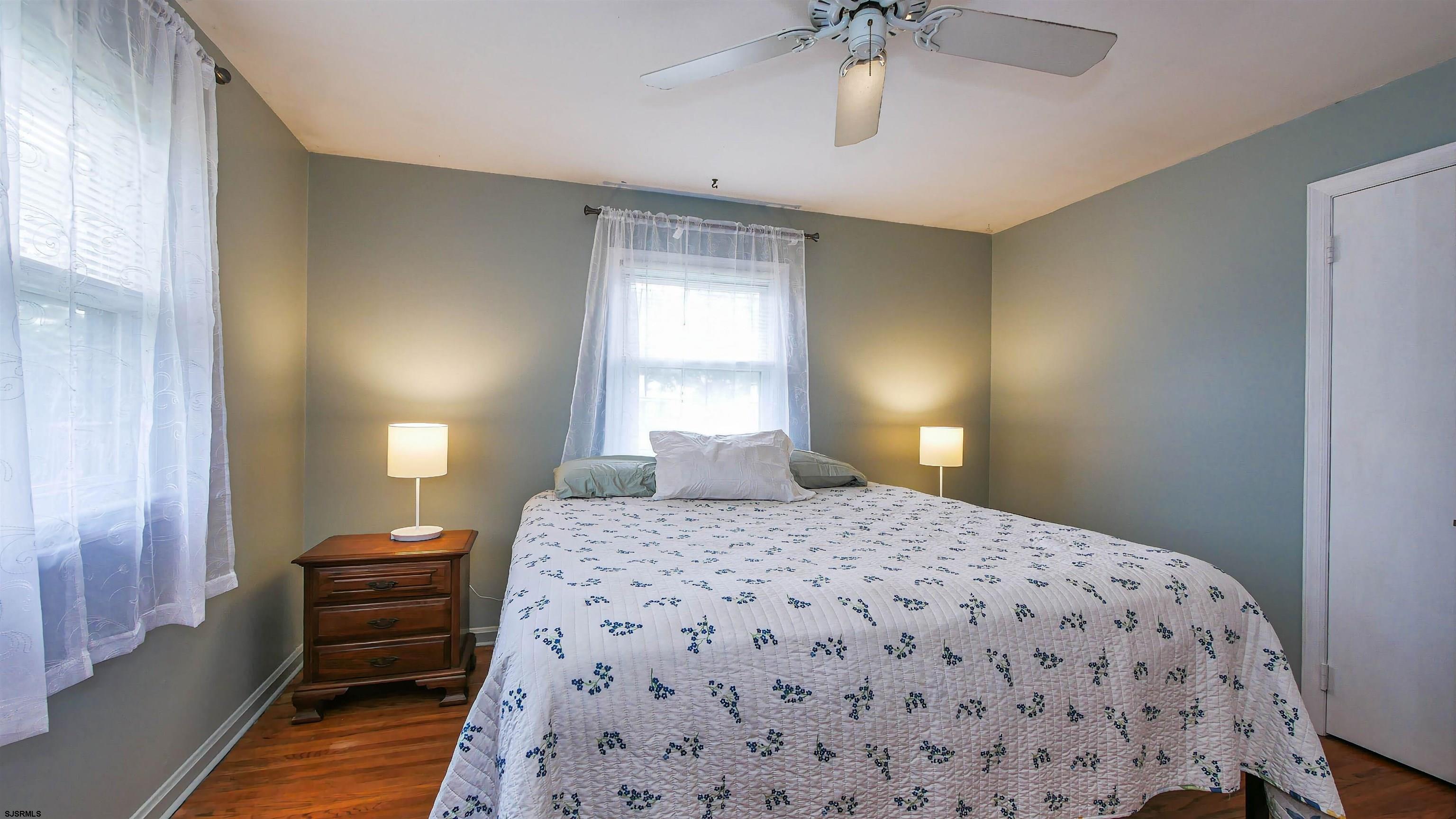 2 Rose Lane Somers Point, NJ 08244 - Photo 19 of 43 a bedroom with a bed and a chandelier