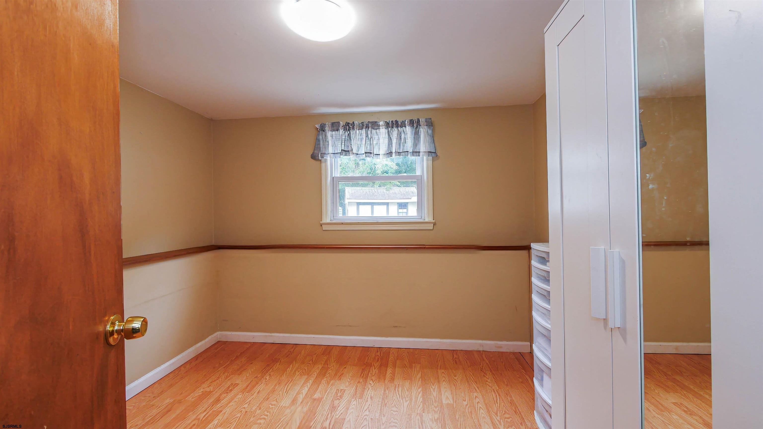 2 Rose Lane Somers Point, NJ 08244 - Photo 24 of 43 a view of an empty room with wooden floor and a window