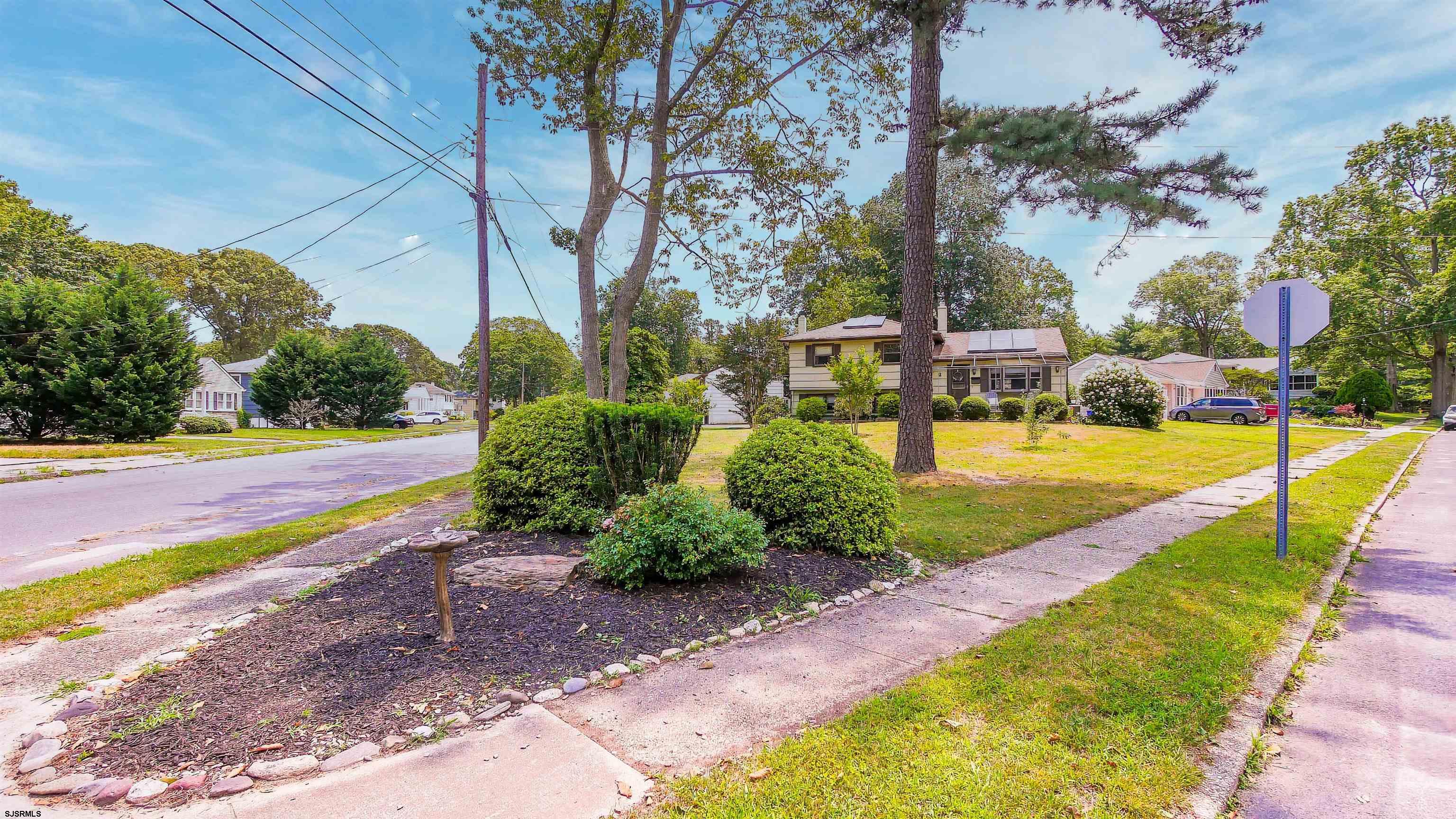 2 Rose Lane Somers Point, NJ 08244 - Photo 40 of 43 a view of a swimming pool with lawn chairs under an umbrella