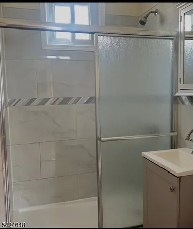 a bathroom with a shower and a sink