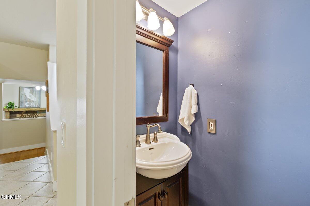 5024 West Wooley Road Oxnard, CA 93035 - Photo 13 of 33 a bathroom with a sink a mirror and a toilet
