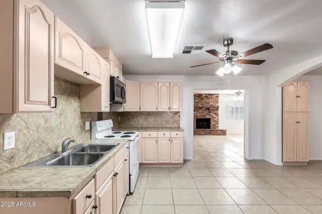 a view of a kitchen with electric appliances