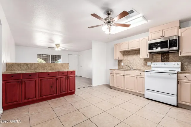 a kitchen with stainless steel appliances granite countertop a sink a stove and cabinets