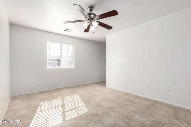 a view of a room with a ceiling fan