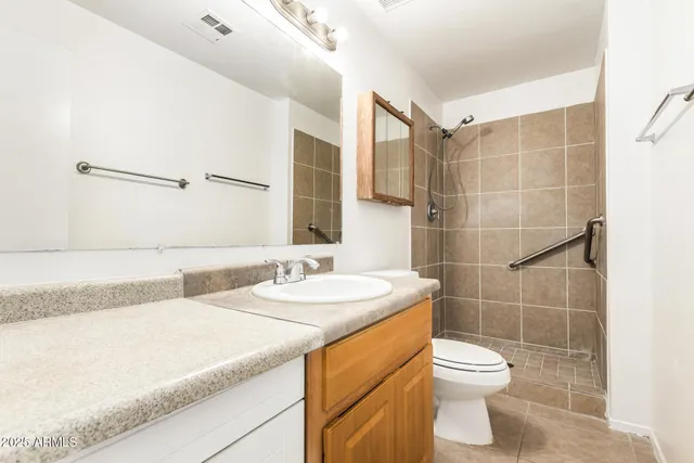 an empty room with a window and a ceiling fan