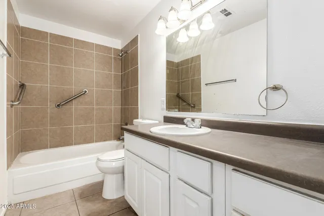 an empty room with a ceiling fan and carpet