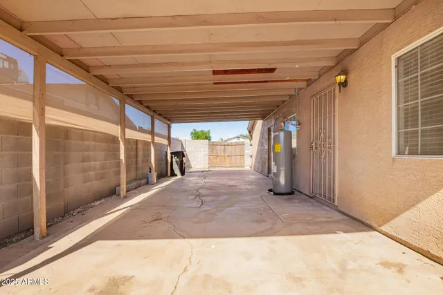 an empty room with chandelier fan