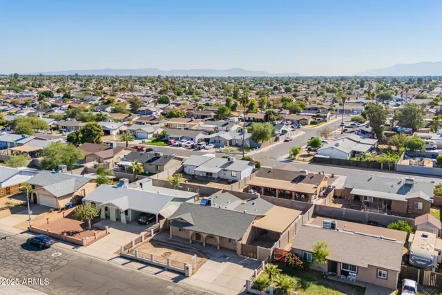 a view of a house with swimming pool and sitting area