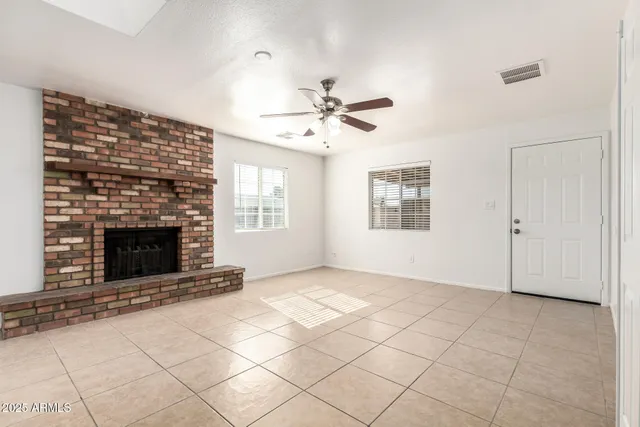 a view of a room with a ceiling fan and a rug