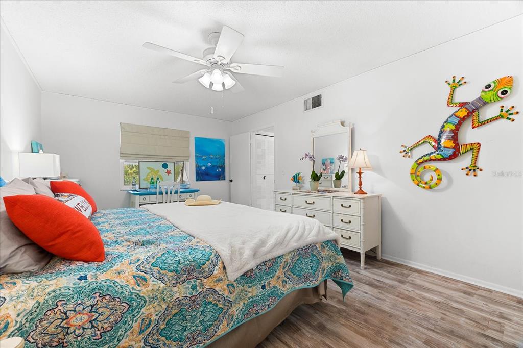 5641 Midnight Pass Road, Unit 902 Sarasota, FL 34242 - Photo 28 of 81 a bedroom with a bed and ceiling fan