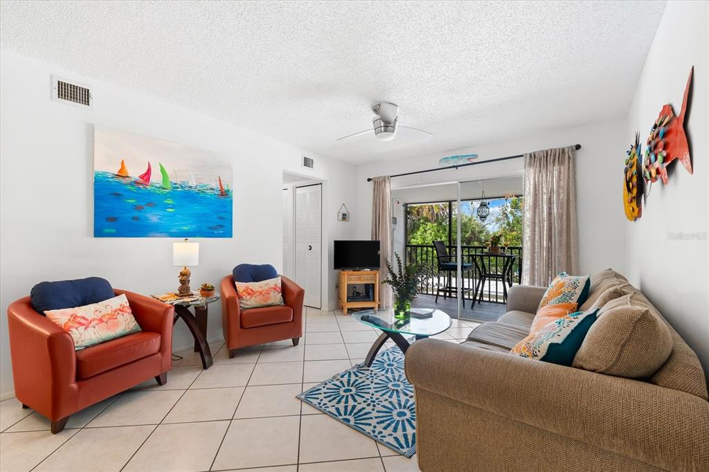 5641 Midnight Pass Road, Unit 902 Sarasota, FL 34242 - Photo 39 of 81 a living room with furniture and a large window