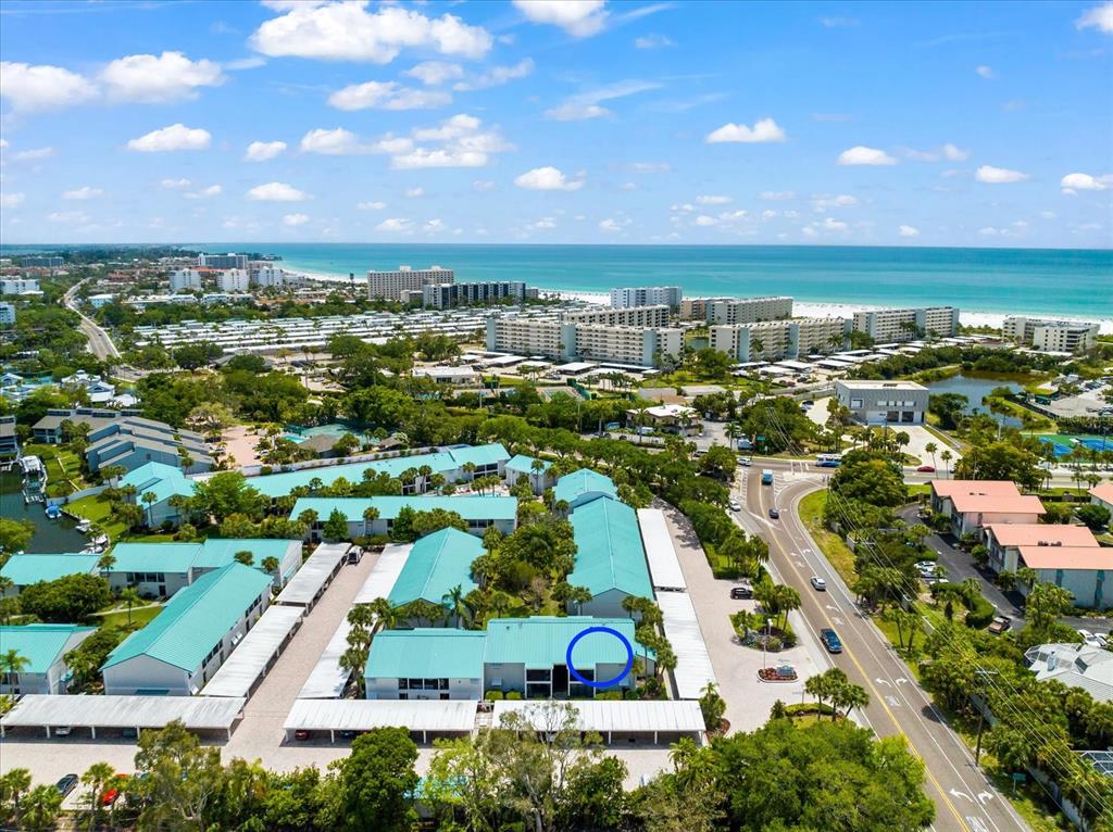5641 Midnight Pass Road, Unit 902 Sarasota, FL 34242 - Photo 70 of 81 an aerial view of residential building with outdoor space and trees