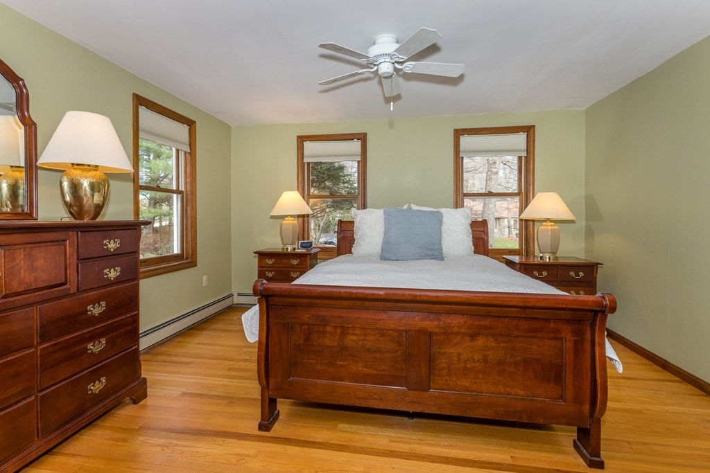 49 Angela Street Canton, MA 02021 - Photo 13 of 25 a bedroom with a bed and wooden floor