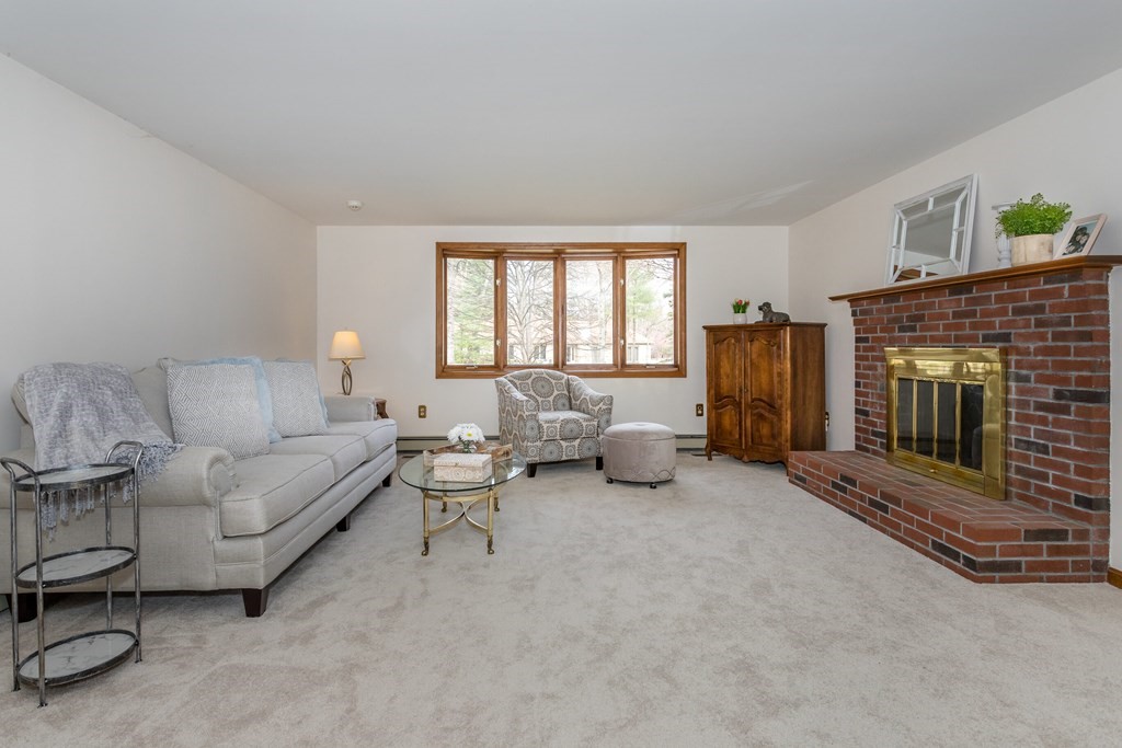 49 Angela Street Canton, MA 02021 - Photo 3 of 25 a living room with furniture and a fireplace
