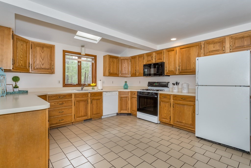 49 Angela Street Canton, MA 02021 - Photo 6 of 25 a kitchen with cabinets stainless steel appliances and a window