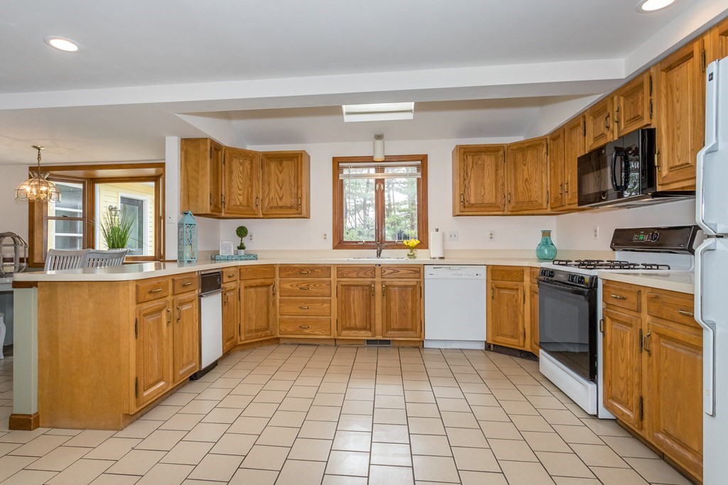 49 Angela Street Canton, MA 02021 - Photo 7 of 25 a kitchen with a sink window and cabinets