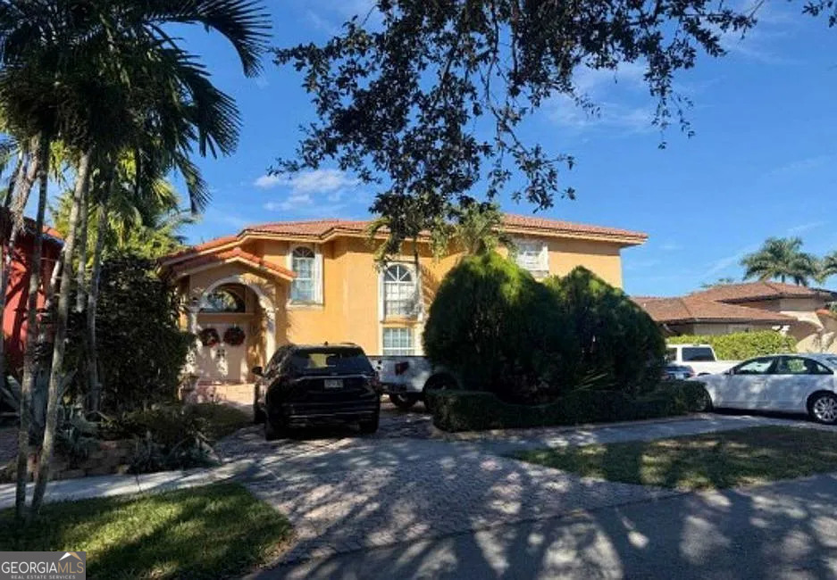 16013 Southwest 43rd Street Miami, FL 33185 - Photo 3 of 6 a car parked in front of a house