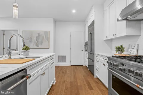 a kitchen with a sink stove and refrigerator