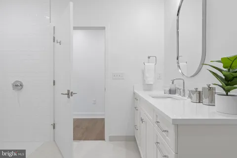 a bathroom with double vanity sink and a mirror