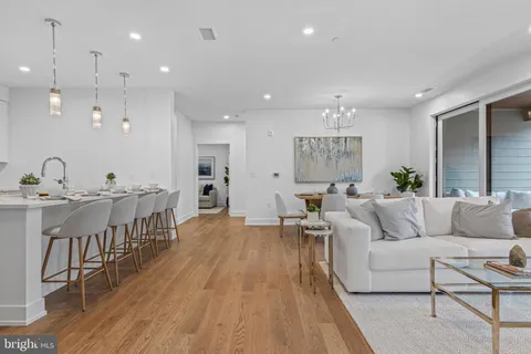 a living room with furniture or wooden floor and a chandelier
