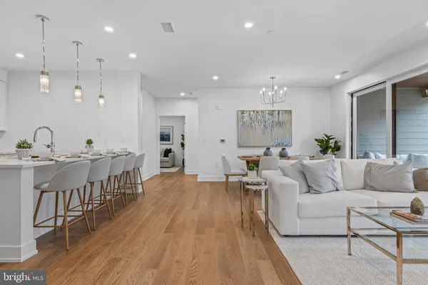a living room with furniture or wooden floor and a chandelier