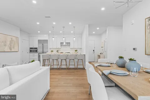 a living room with kitchen island furniture and a table