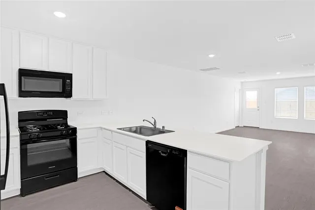 a kitchen with stainless steel appliances a refrigerator and a stove top oven