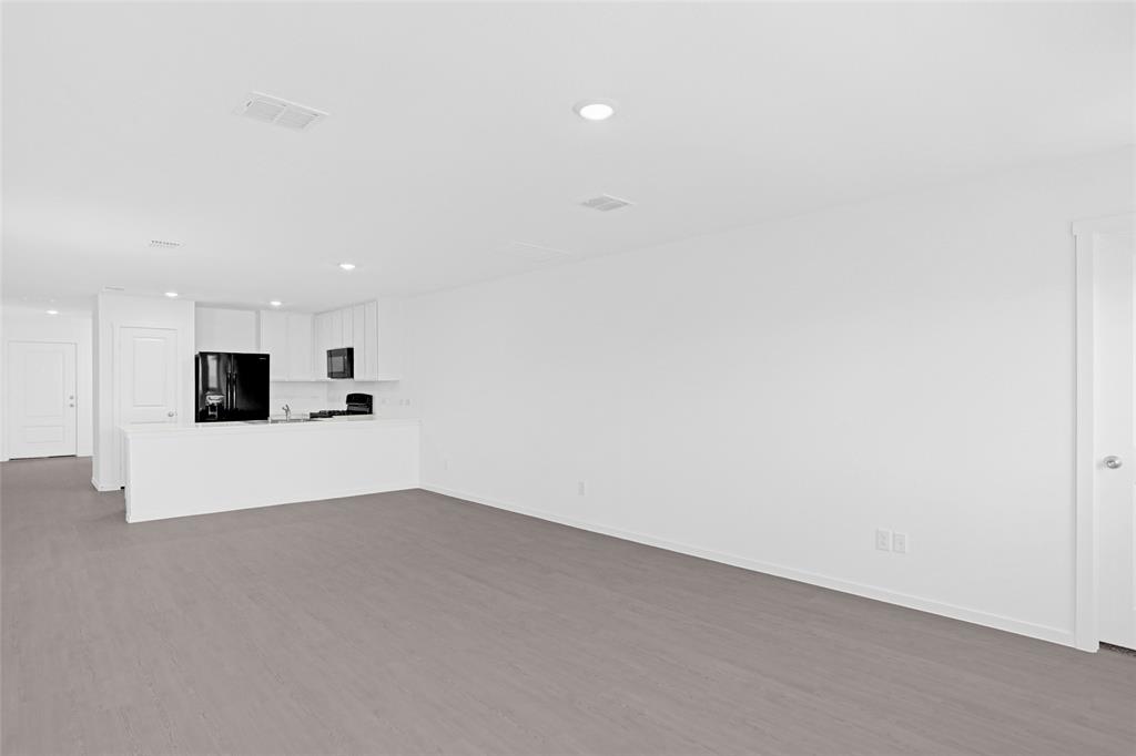 1033 Raintree Road Princeton, TX 75407 - Photo 12 of 25 a view of kitchen with kitchen island microwave and stove
