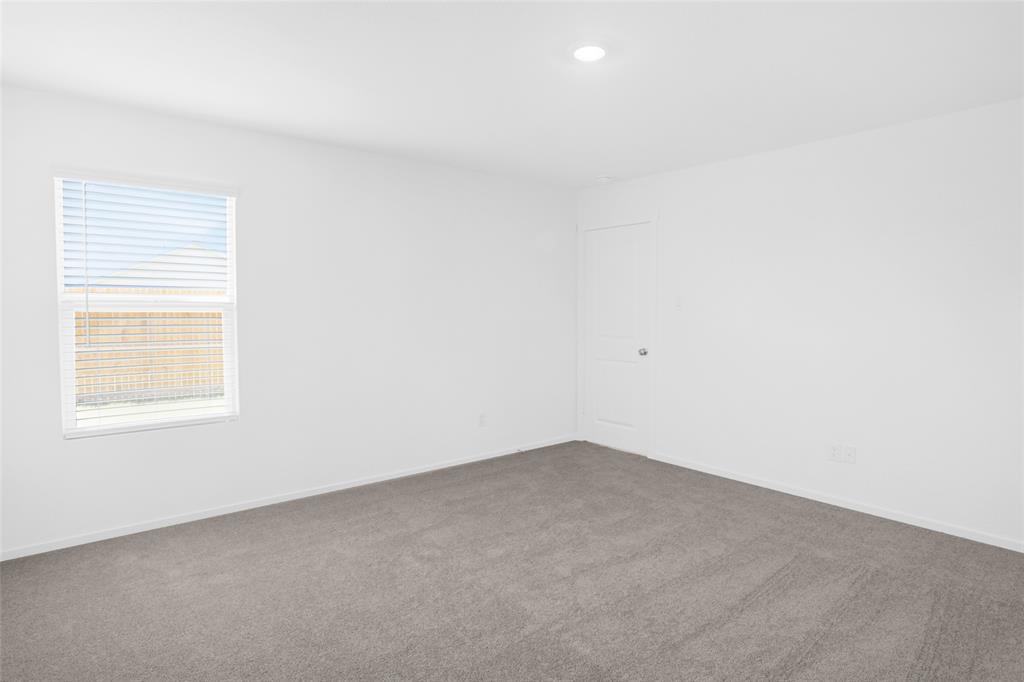 1033 Raintree Road Princeton, TX 75407 - Photo 16 of 25 an empty room with a window