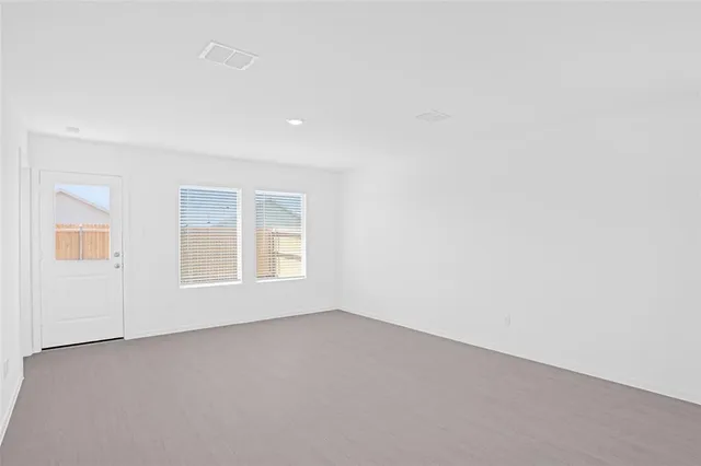 a view of kitchen with kitchen island microwave and stove