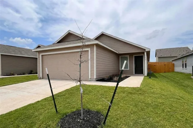 a front view of a house with yard