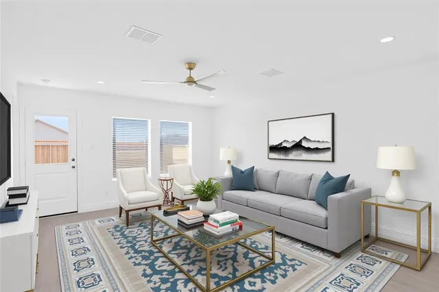 a living room with furniture and a wooden floor