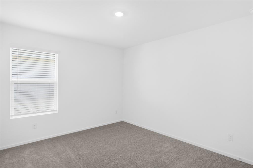 1033 Raintree Road Princeton, TX 75407 - Photo 22 of 26 an empty room with a window