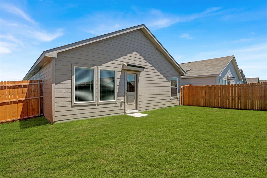 1033 Raintree Road Princeton, TX 75407 - Photo 4 of 25 a front view of a house with a garden